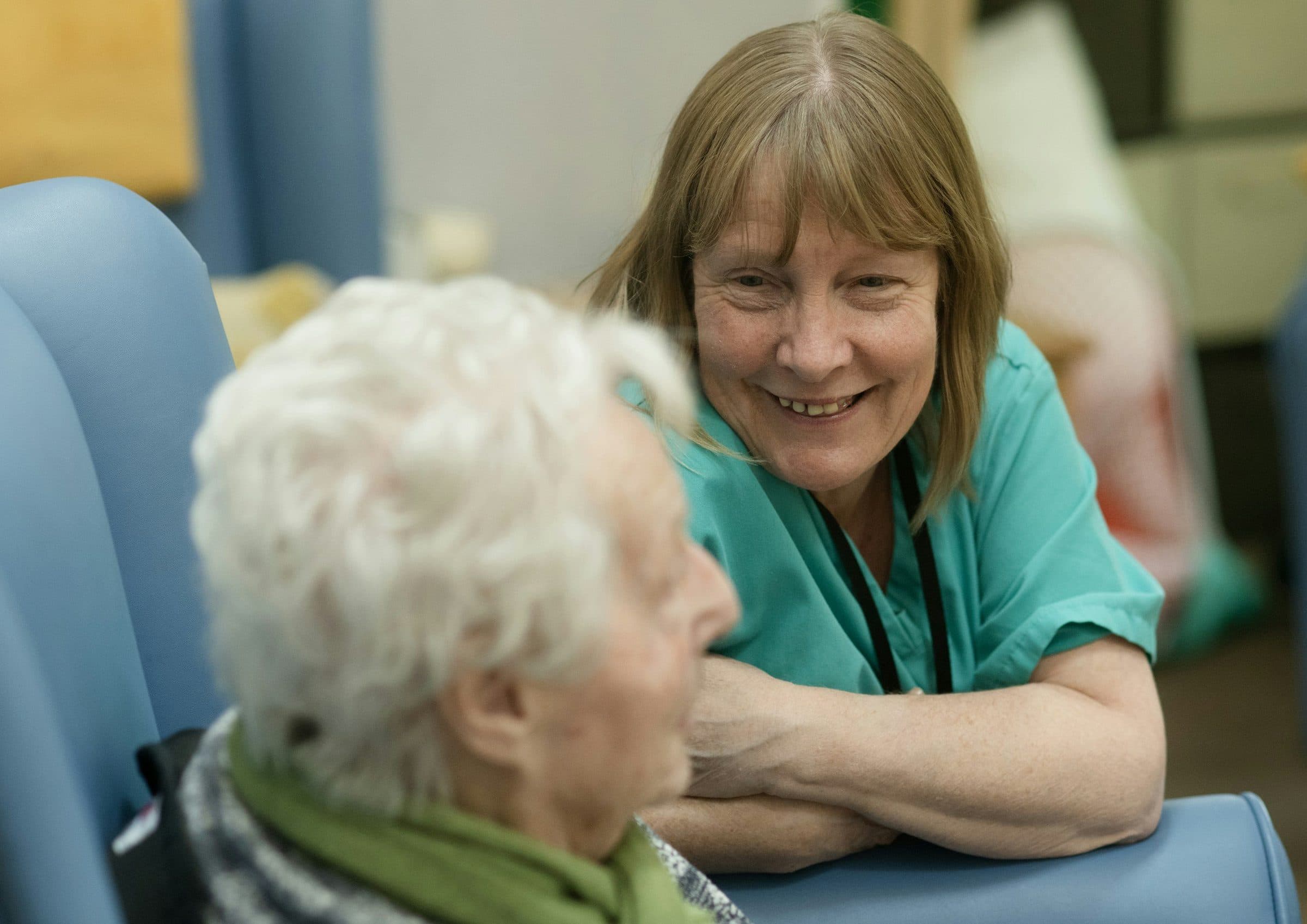 A care professional speaking with an older patient
