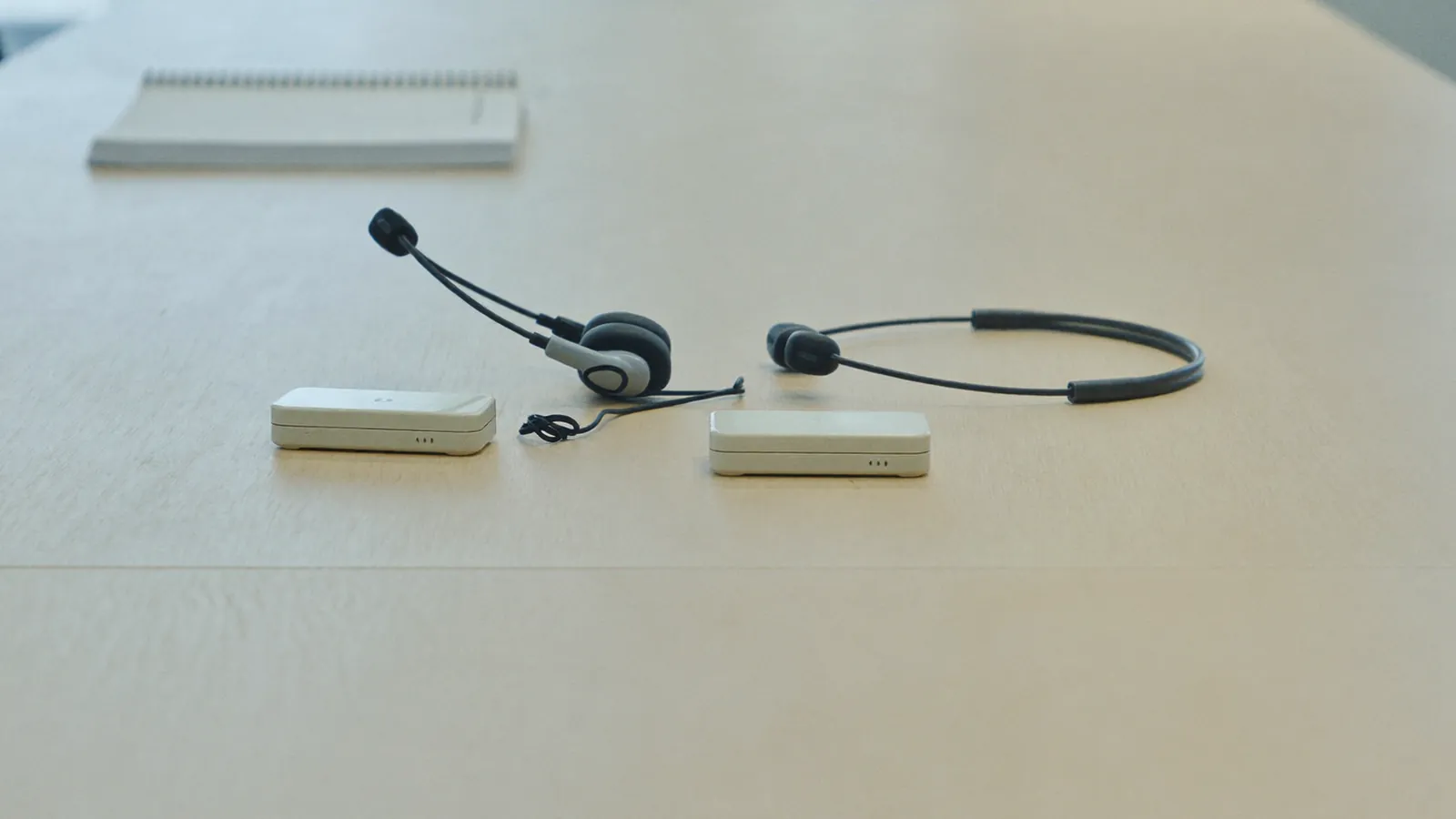 Interpreter headsets and receiver on a conference table for a legal proceeding