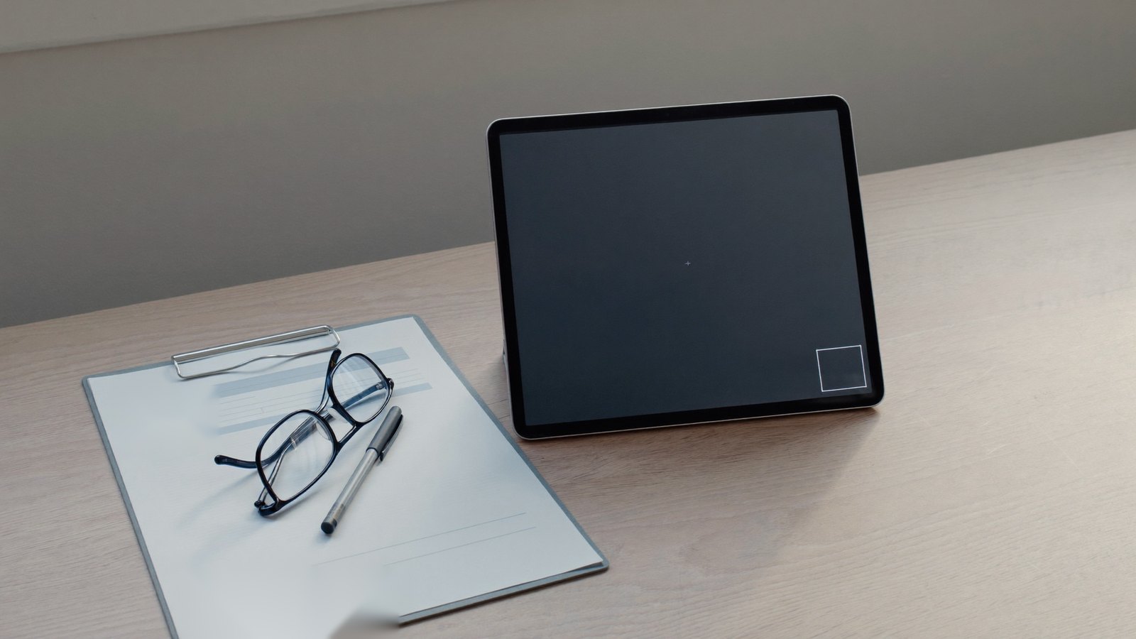 Tablet set up for a video remote interpreting session beside an intake form